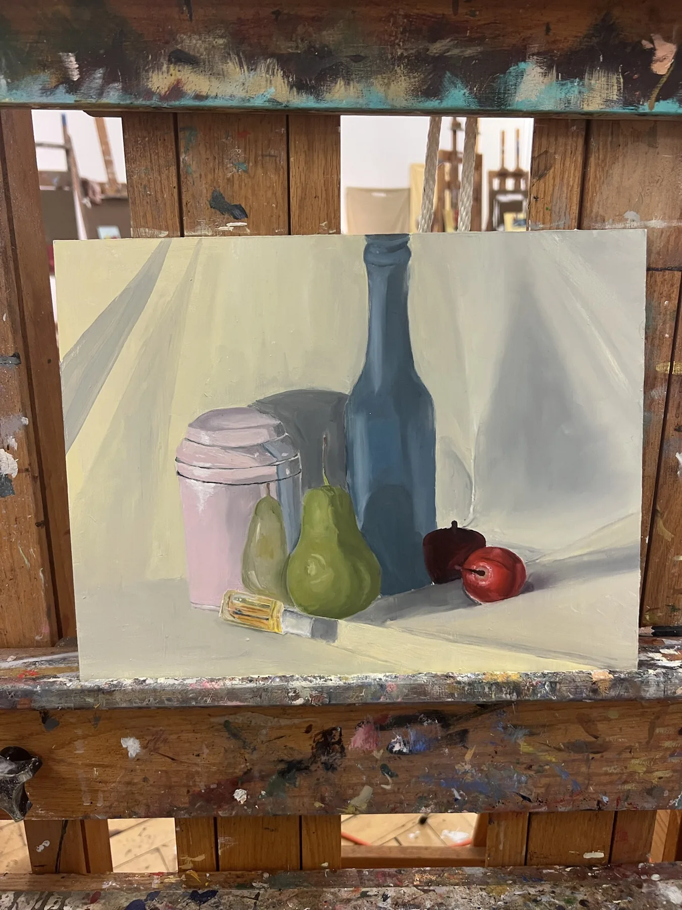 Still life painting with bottles, fruit, and vessels