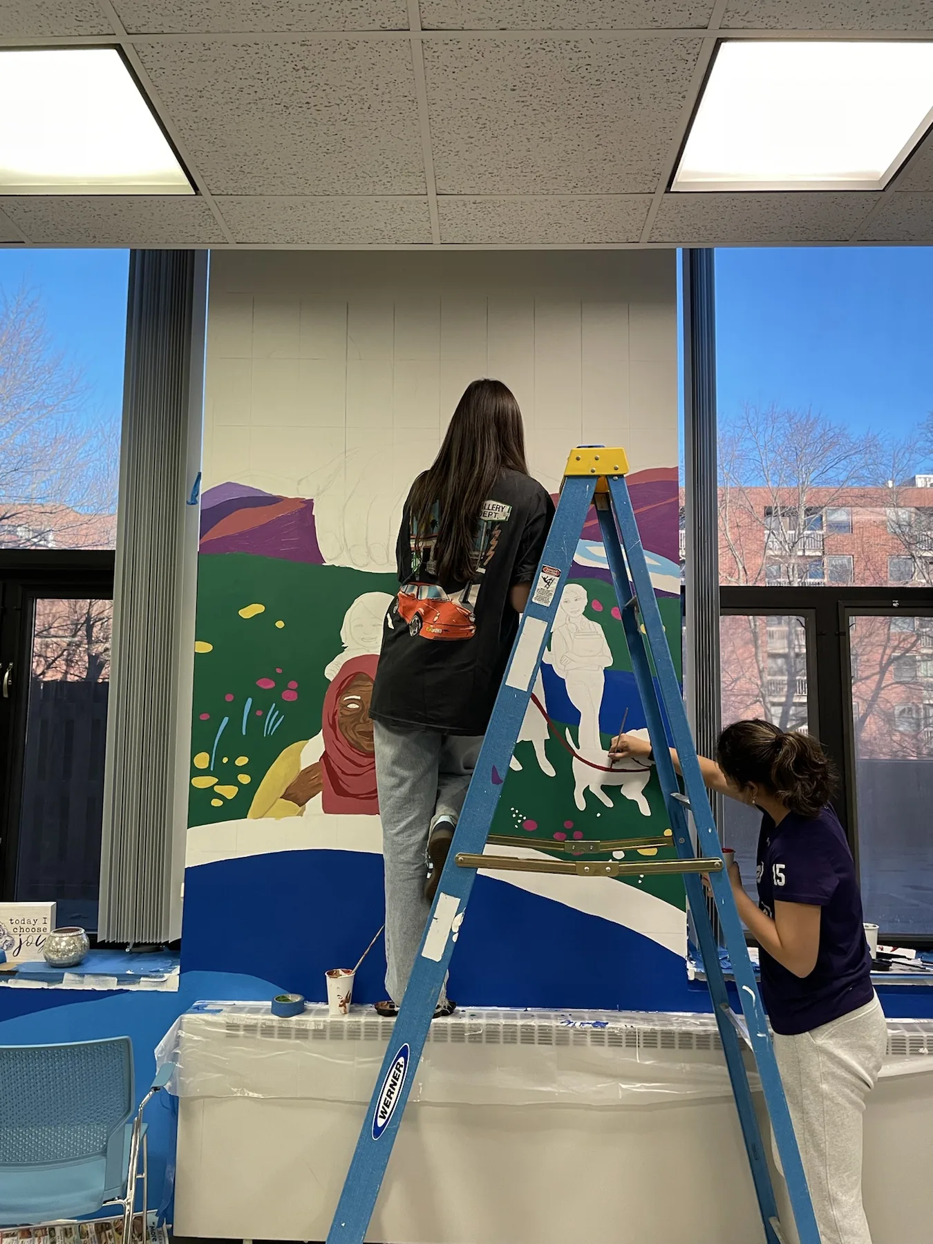 Artists working on a collaborative mural