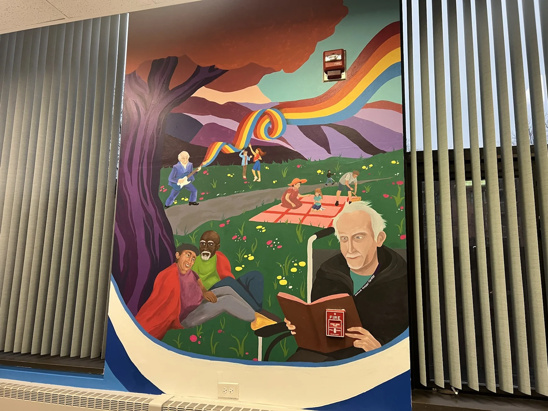 Detail of a colorful mural with figures and landscape
