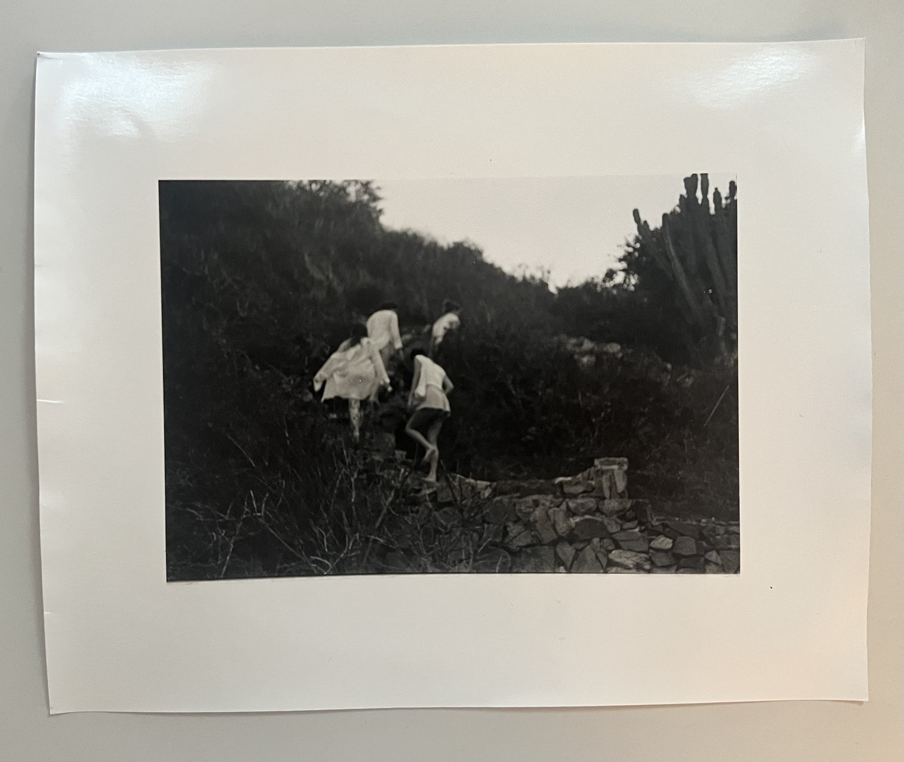 Monochrome photograph of figures in a landscape