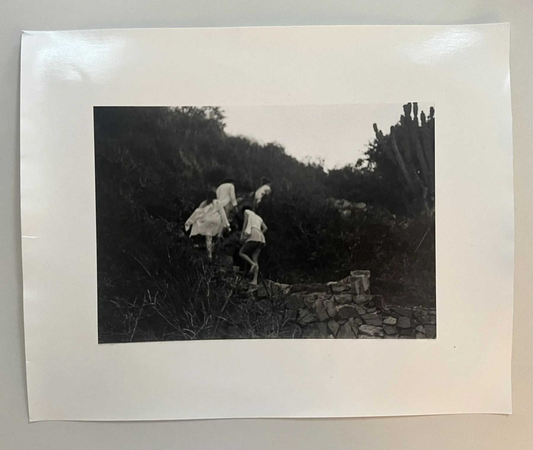 Monochrome photograph of figures in a landscape