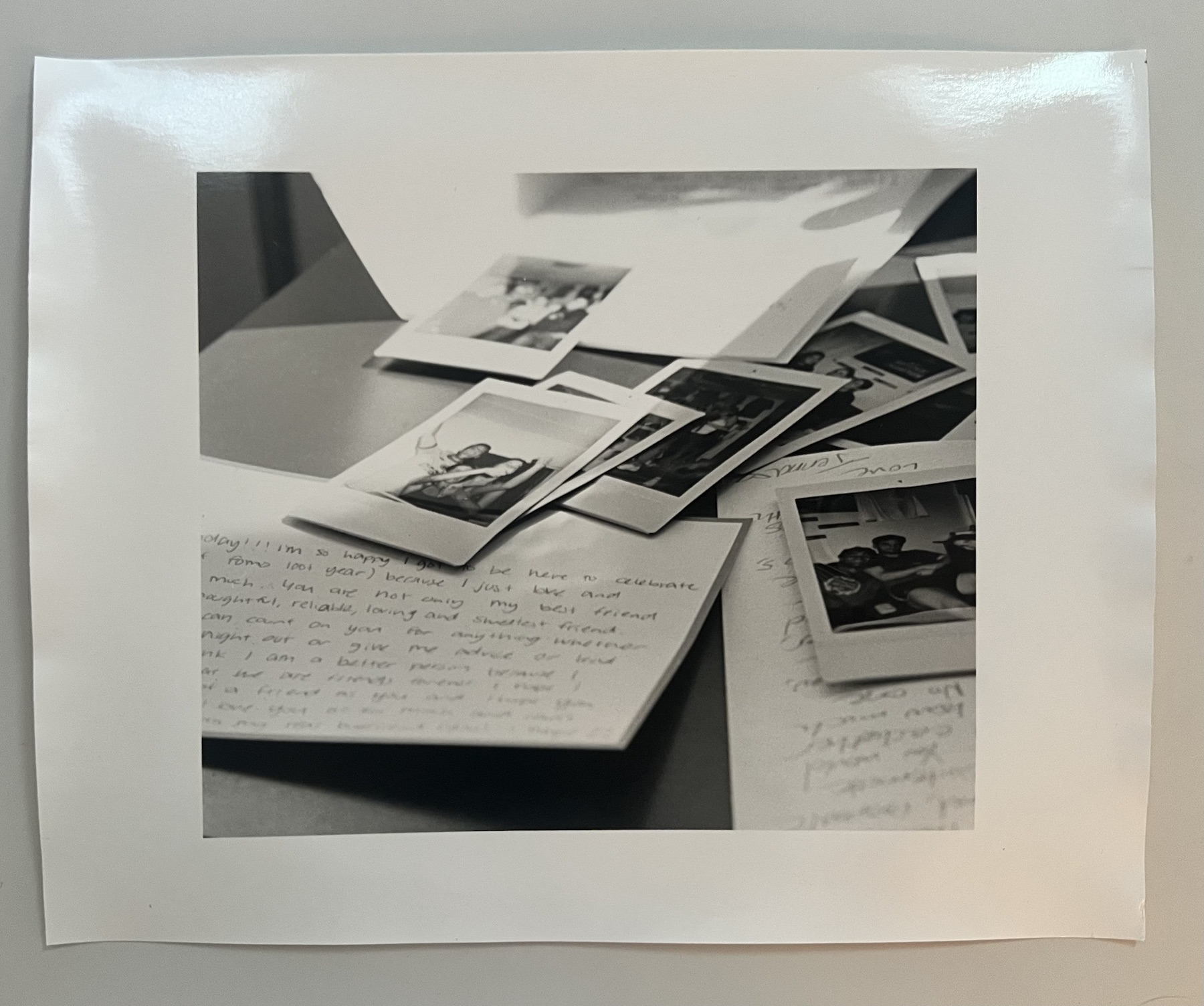 Monochrome photograph of prints and handwritten notes