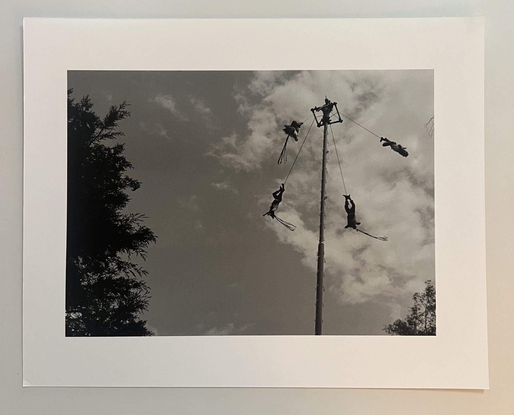 Monochrome photograph of figures suspended in the sky