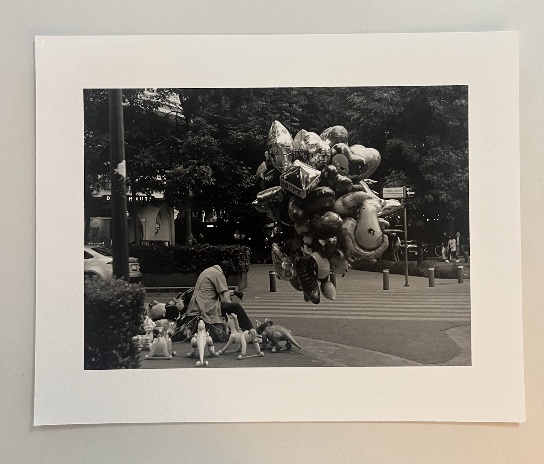 Monochrome street photograph with balloons