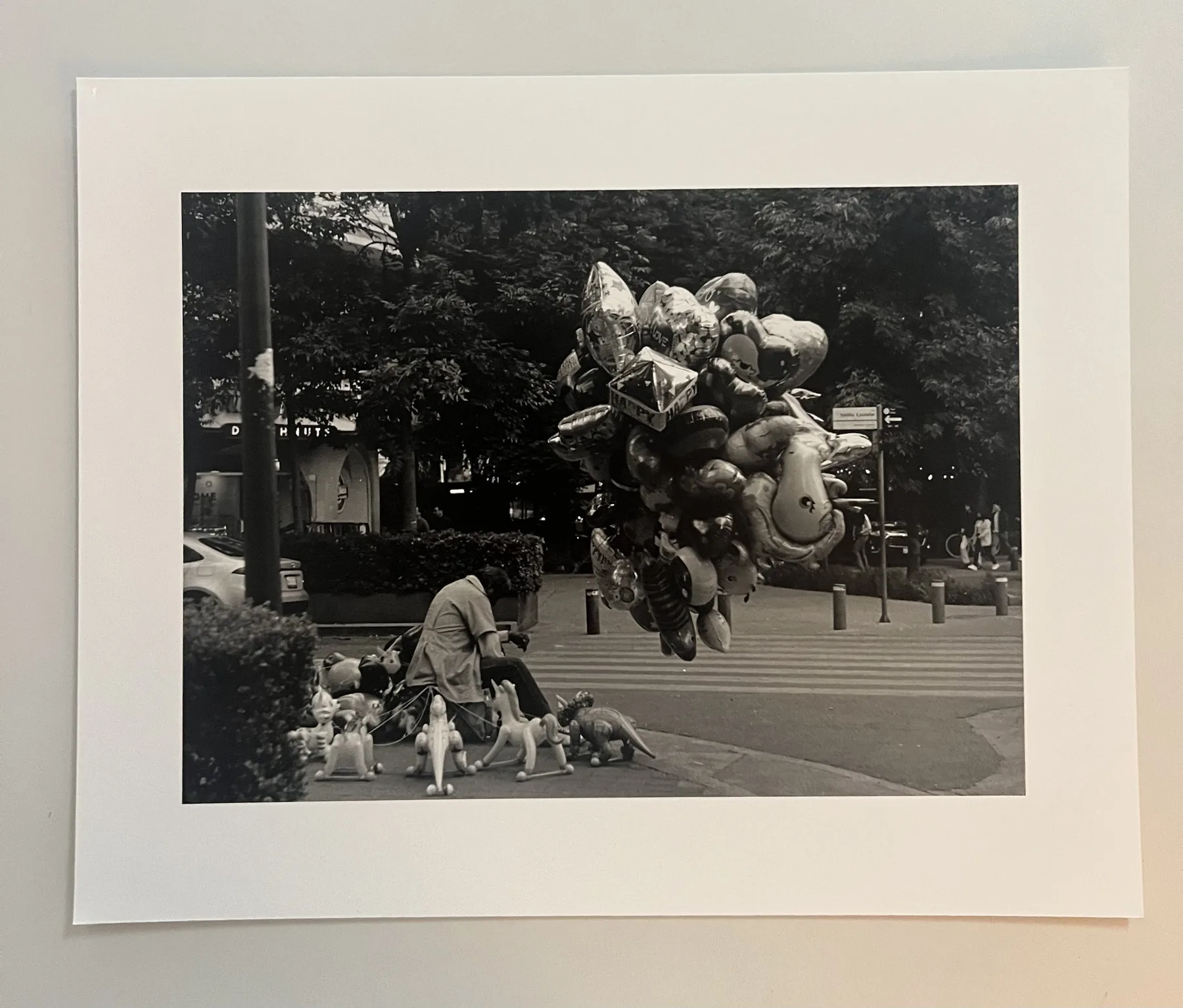 Monochrome street photograph with balloons