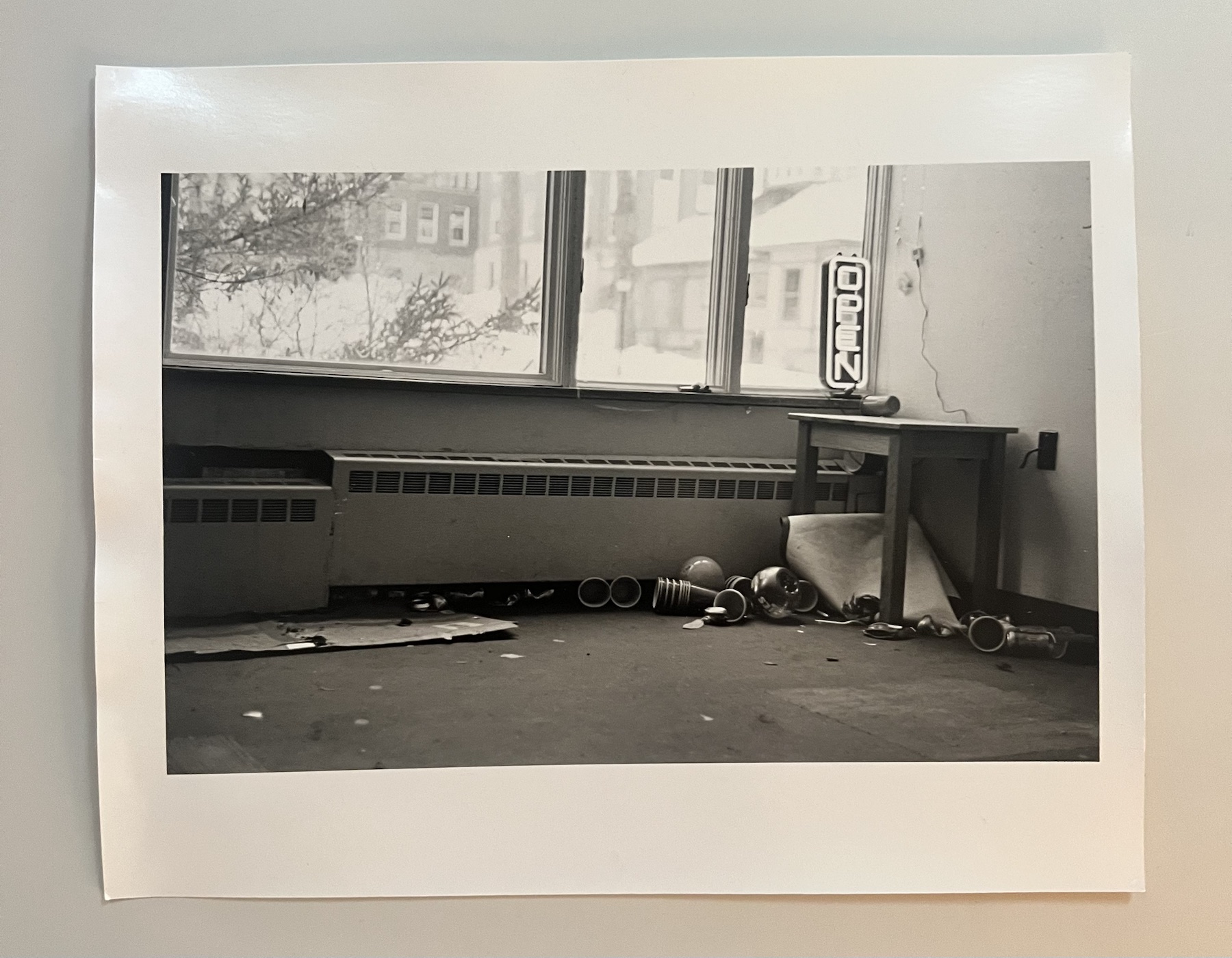Monochrome photograph of an interior beneath a window